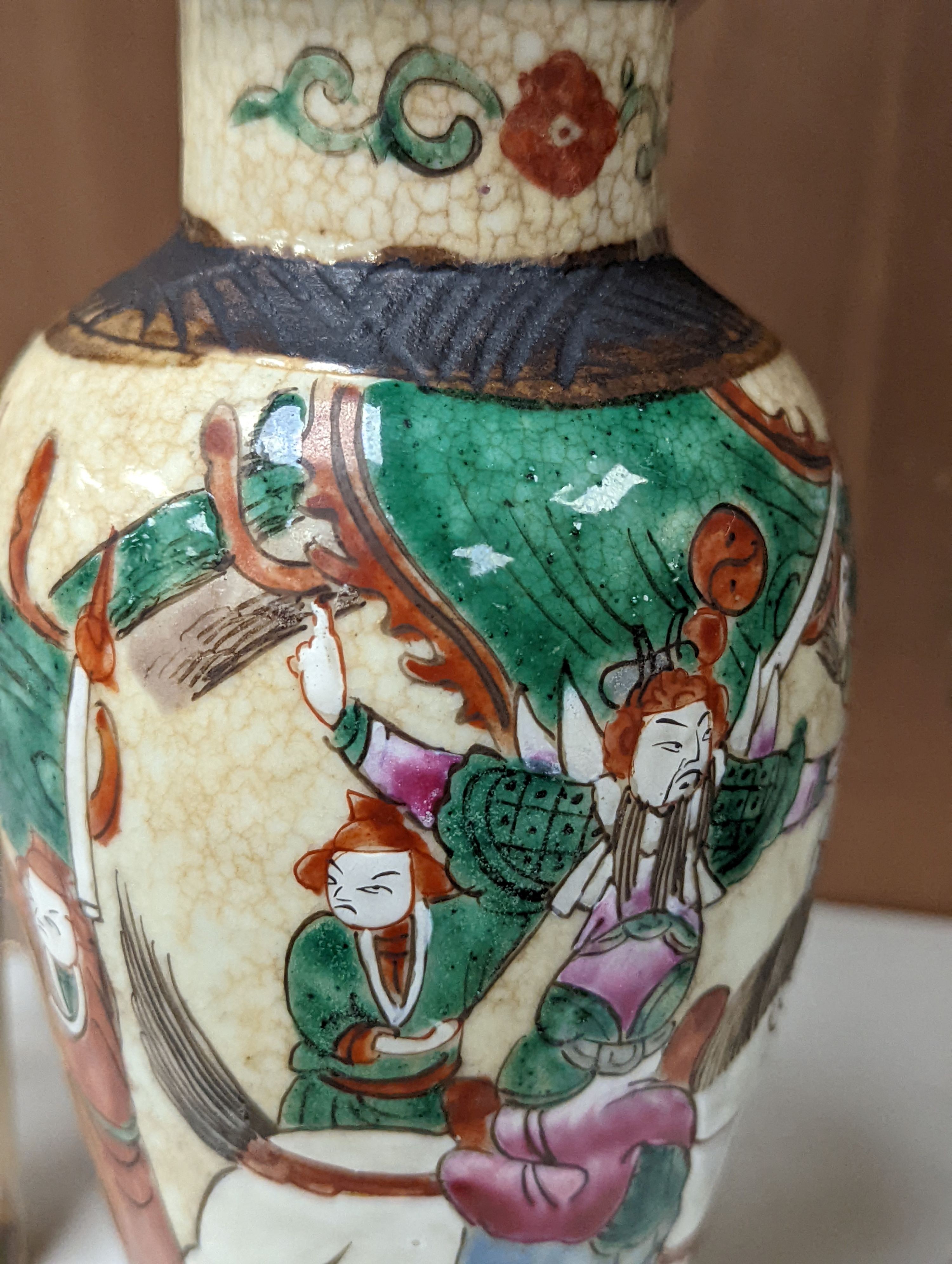 A pair of Chinese famille rose crackle glaze baluster jars and covers, 27cm.